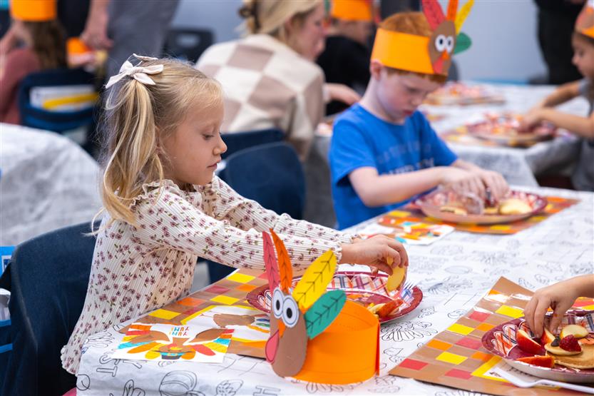 Creekside kindergartners and their families enjoy breakfast
